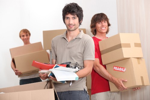 Furniture being carried down stairs during a Swisscottage home relocation