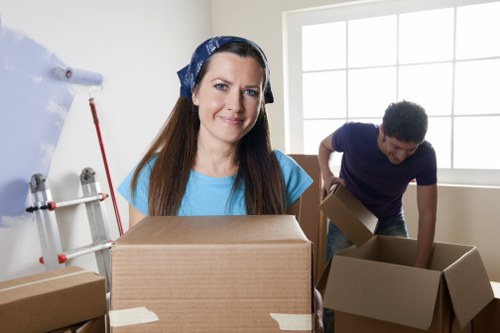 Professional movers carrying items through a residential corridor