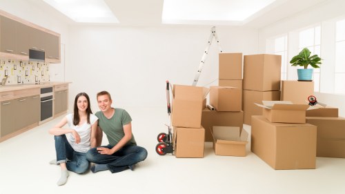 Professional movers handling boxes and furniture in Swisscottage