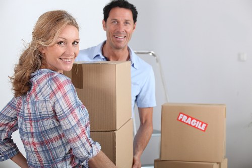 Removal crew wearing PPE while moving furniture